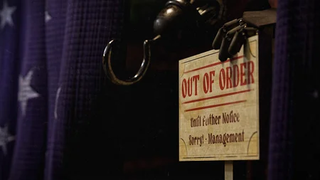 Foxy's purple curtain with Out of Order sign and his claw peeking through